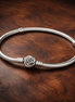 Pandora Moments Rose in Bloom Clasp Snake Chain Bracelet — display on walnut