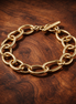 Organically Shaped Link Bracelet — display on walnut