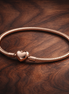 Pandora Moments Heart Clasp Snake Chain Bracelet — display on walnut