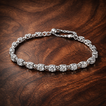 Bow Chain Bracelet — display on walnut