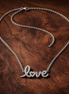 Sparkling Handwritten Love Collier Necklace — display on walnut