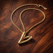 Organically Shaped Heart Pendant Necklace — display on walnut