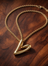 Organically Shaped Heart Pendant Necklace — display on walnut
