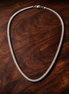 Tennis Choker Necklace — display on walnut