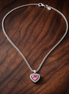Pink Elevated Heart Necklace — display on walnut