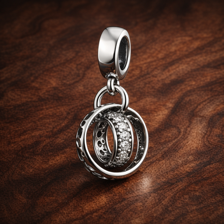 Interlocking Rings - Sterling Silver Interlocking Rings Dangle Charm With Sparkling Stones — display on walnut