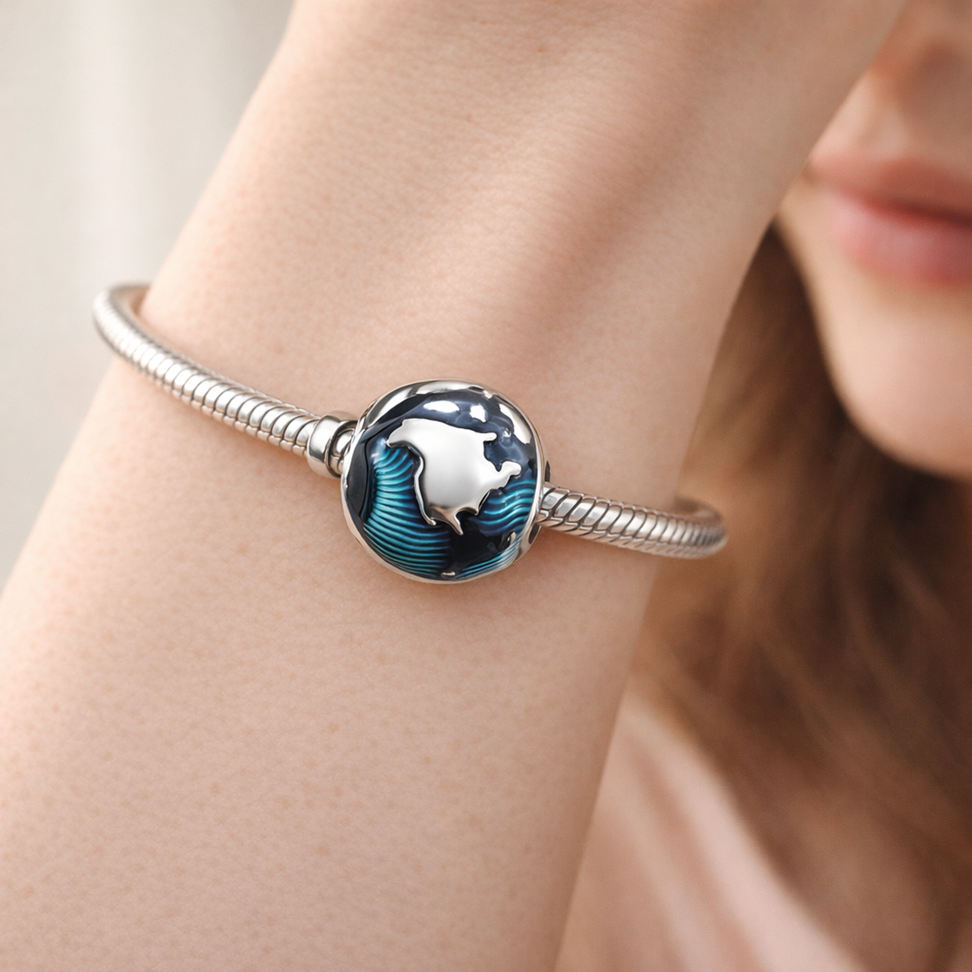 Blue Globe Clip Charm — worn on wrist