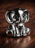 Ellie the Elephant Charm — display on walnut