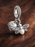 Glow-in-the-dark Firefly Dangle Charm — display on walnut