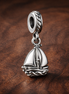 Silver Sailboat Charm - Silver Sailboat Dangle Charm — display on walnut