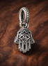 Protective Hamsa Hand Dangle Charm — display on walnut