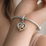 Two-tone Happy Anniversary Dangle Charm — worn on wrist