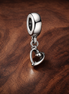 Stethoscope Heart Dangle Charm — display on walnut