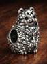 Textured Hedgehog Charm - Silver Hedgehog Woodland Bead — display on walnut