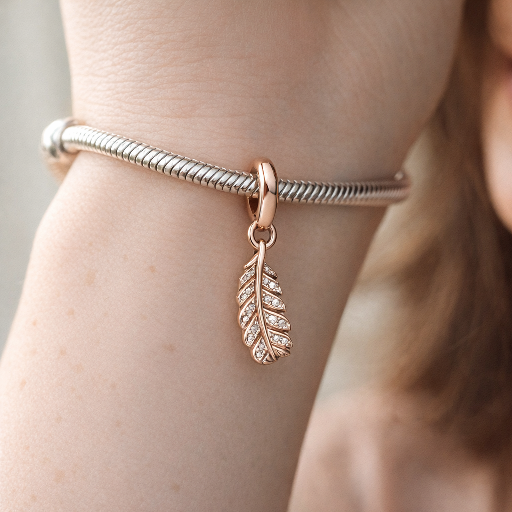 Rose Gold Plated Feather Charm - Rose Gold Plated Feather Dangle Charm — worn on wrist