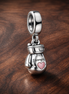 Pink Potion Bottle Charm - Pink Potion Bottle Dangle Charm — display on walnut