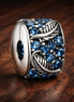 Curved Feather & Pavé Clip Charm — display on walnut