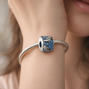 Curved Feather & Pavé Clip Charm — worn on wrist