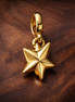 Gold Plated Origami Star Charm - Gold Plated Origami Star Dangle Charm — display on walnut