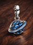 Blue Planet Charm - Blue Saturn Planet Charm — display on walnut