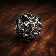 Clear Floral Medallion Bead - Clear Floral Pavé Medallion Bead — display on walnut