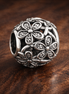 Open Daisy Bead - Silver Open Daisy Bead — display on walnut