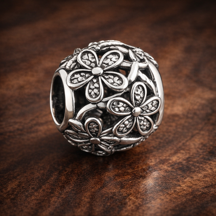 Open Daisy Bead - Silver Open Daisy Bead — display on walnut