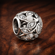 Leaf Vine Bead - Silver Leaf Vine Openwork Bead — display on walnut