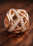 Rose Gold Plated Lattice Bead - Rose Gold Plated Crystal Lattice Bead — display on walnut