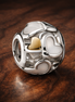 White Heart Window Bead - White Enamel Heart Window Charm — display on walnut