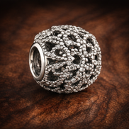 Silver Floral Vine Bead - Silver Floral Vine Sparkle Charm — display on walnut