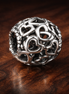 Silver Love Knot Bead - Silver Open Love Knot Charm — display on walnut