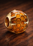 Amber Honeycomb Bead - Amber Honeycomb Enamel Charm — display on walnut