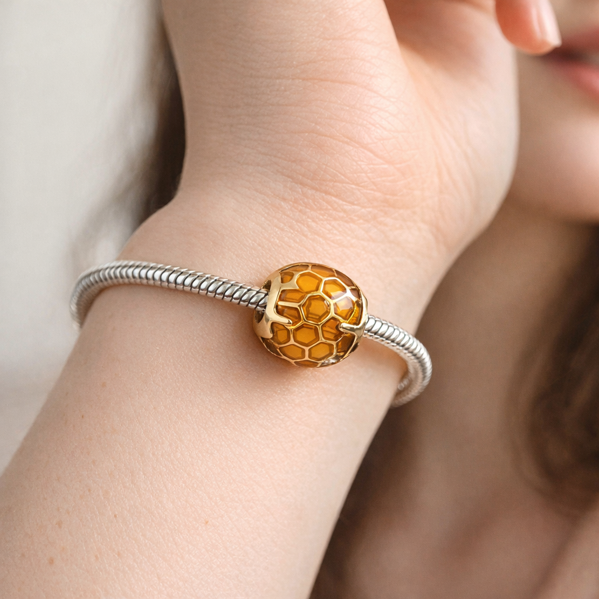 Amber Honeycomb Bead - Amber Honeycomb Enamel Charm — worn on wrist