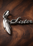 Sister Heart Charm — display on walnut