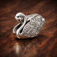 Silver Swan Charm - Silver Swan Sparkle Charm — display on walnut