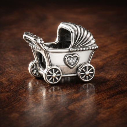 Baby Carriage Charm - Silver Baby Carriage Charm — display on walnut