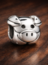 Cow Face Charm - Smiling Cow Face Charm — display on walnut
