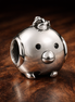 Pig Face Charm - Smiling Pig Face Charm — display on walnut