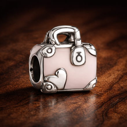 Pink Travel Bag Charm — display on walnut