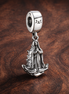 Virgin of Guadalupe Motif Dangle Charm — display on walnut