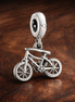 Bicycle Charm - Bicycle Dangle Charm — display on walnut