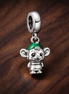 Monkey Elf Charm - Tiny Monkey with Green Hat Charm — display on walnut