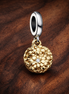 My Pandora Two-tone Daisy Double Dangle Charm — display on walnut