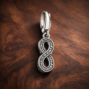 Infinity Charm - Sparkling Infinity Dangle Charm — display on walnut