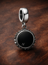 Icon Dangle Charm — display on walnut