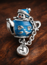Blue Wizard Teacup Charm - Blue Wizard Teacup Dangle Charm — display on walnut