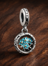 Turquoise Floral Charm - Turquoise Flower Medallion Charm — display on walnut