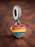 Pride Rainbow Heart Dangle Charm — display on walnut