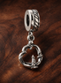 Pretzel Dangle Charm — display on walnut